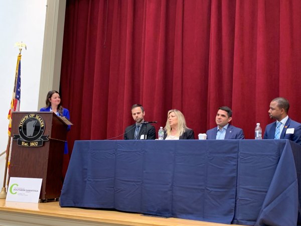 Seated from left to right – Dr. Jonathan Ashdown, Cindy Quade, Daniel Arnoff, and Admar Semedo participate in an “Inside Malta” panel discussion moderated by Stefanie Gouvis (far left behind the podium). Photo by Jonathon Norcross.