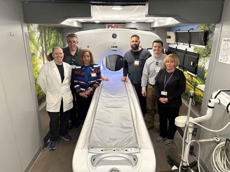Members of the Saratoga Hospital team pose alongside the GE Healthcare Omni Legend PET/CT system. Photo provided by Darlene Alvarado. 