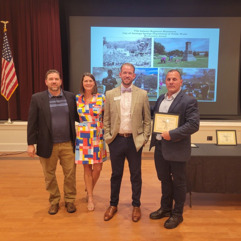 A 2022 Preservation Recognition Award for the restoration of the 77th Infantry Monument was presented by the Saratoga Springs Preservation Foundation during a ceremony last week. Pictured: DPW Sign and Art Technician Phil Steffen, SSPF Executive Director Samantha Bosshart, SSPF Board President Adam Favro, and Deputy Commissioner of Public Works Joseph O’Neill. Photo provided.