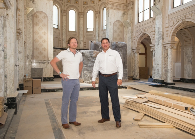 Mark Haworth, left, and Sonny Bonacio pause in The Grove’s nearly completed  “great room,” formerly the Neumann chapel, where residents can relax, congregate, and utilize a computer center.