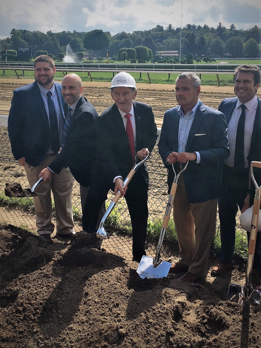 NYRA President and CEO Chris Kay, wearing a white helmet, at ceremonial groundbreaking for the new 1863 Club, which is scheduled to open at the racecourse next year. .