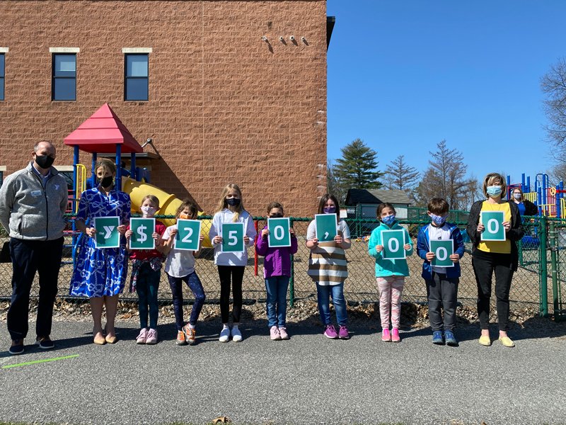 Scott Clark (far left), CEO of the SRYMCA, and Ally Meyers, SRYMCA Board of Directors member (2nd to the left), stand for a group photo with children at the YMCA holding this year’s campaign goal. Photo provided. 