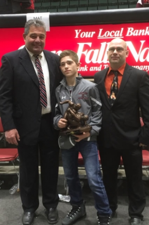 Wrestling coordinator George Chickanis and dad, Bucky Anderson flank Orion with his championship trophy.