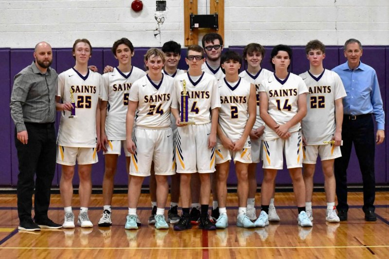 The Saratoga Central Catholic boys’ basketball team poses with trophies from the Mike Beson Memorial Tournament, which the Saints captured with a 54-53 win over North Warren on Nov. 26. Photo courtesy of Saratoga Central Catholic School.