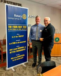 After delivering a speech, Coach Rich Johns poses with Saratoga Springs Rotary Club President Bill Bergan. Photo provided by Rich Johns