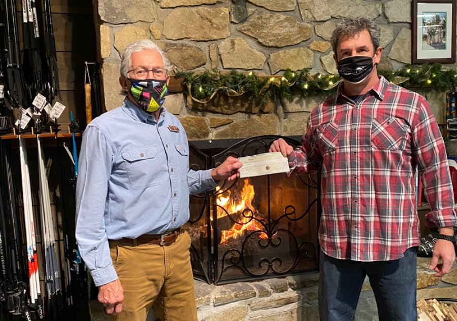 Jack Hay (left), co-owner of The Alpine Sport Shop presents Jimmer Hayes, Director of Double H Ranch Adaptive Sports Program, a check for $1500. Story/Photo credit: Terri-Lynn Pellegri.