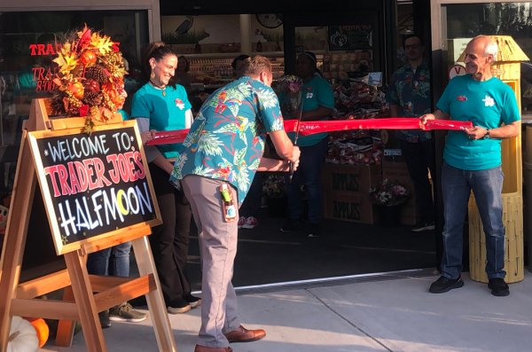 Store Captain Thomas Witte cutting the ribbon at Trader Joe’s Grand Opening in Halfmoon. Photo by Jaynie Ellis.