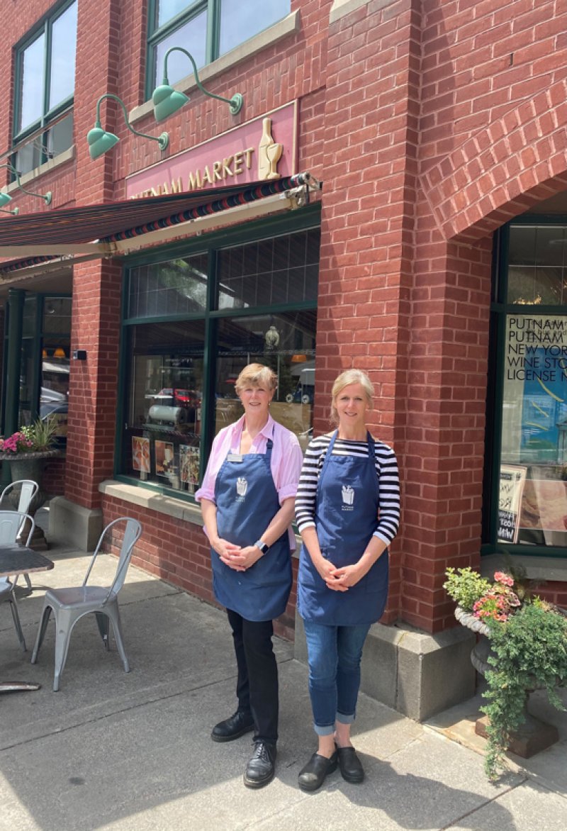 Catharine Hamilton and Gloria Griskowitz, co-owners of Putnam Market, pose in front of their store on Broadway on June 2, 2021. Photo by Thomas Dimopoulos.